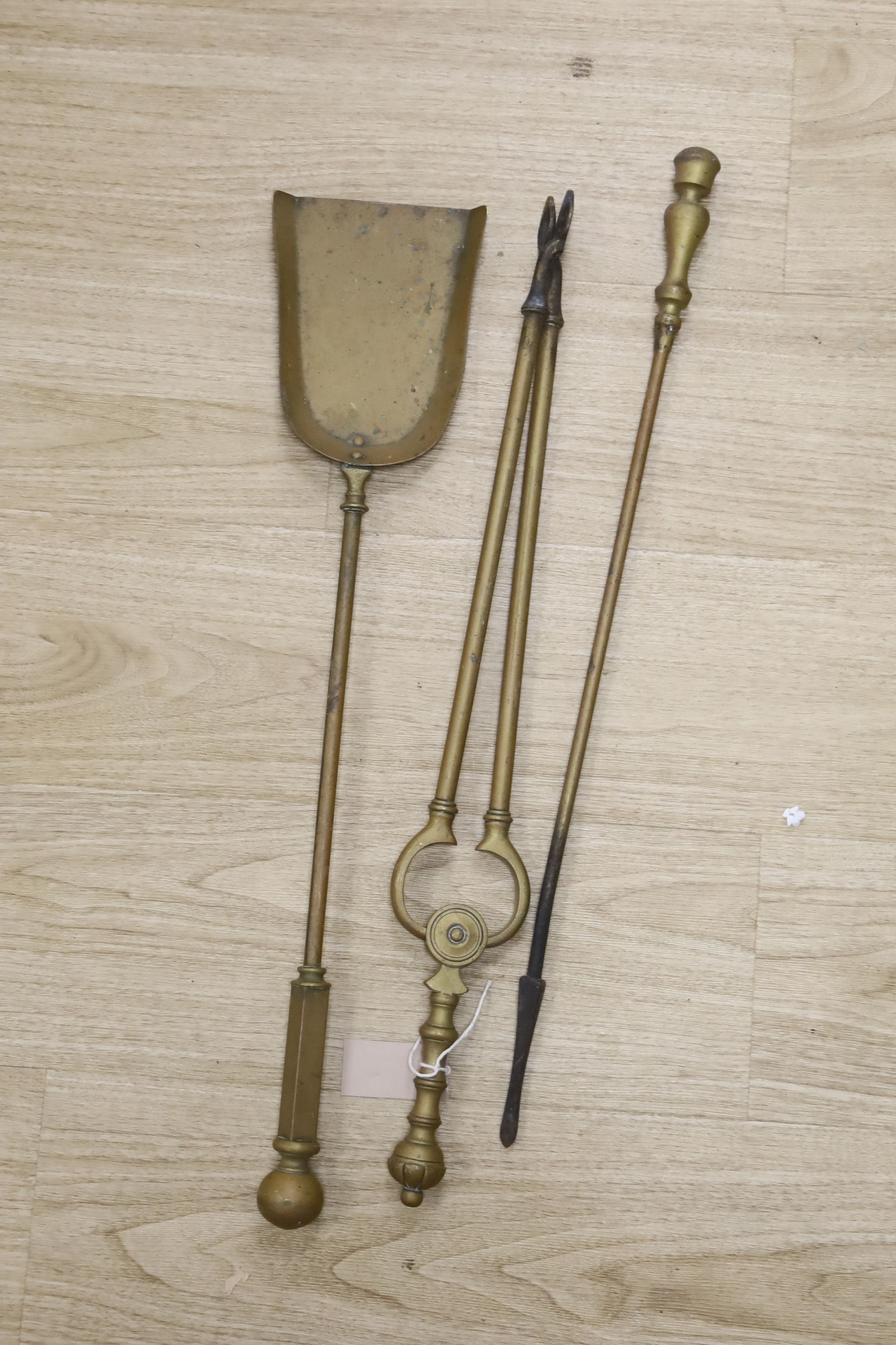 Sundry metalware, including a pair of fire dogs, various fire implements, brass chambersticks and candlesticks and an antique long brass curtain rail
